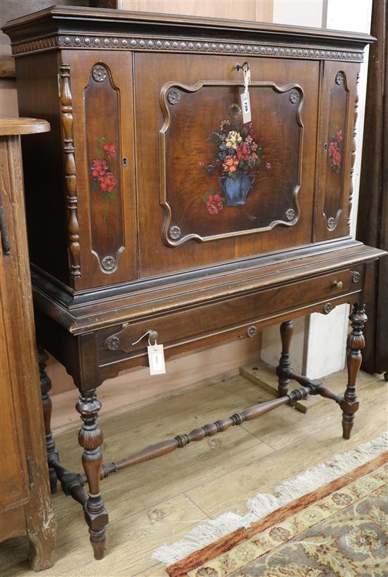 A painted and decorated secretaire cabinet W.102cm